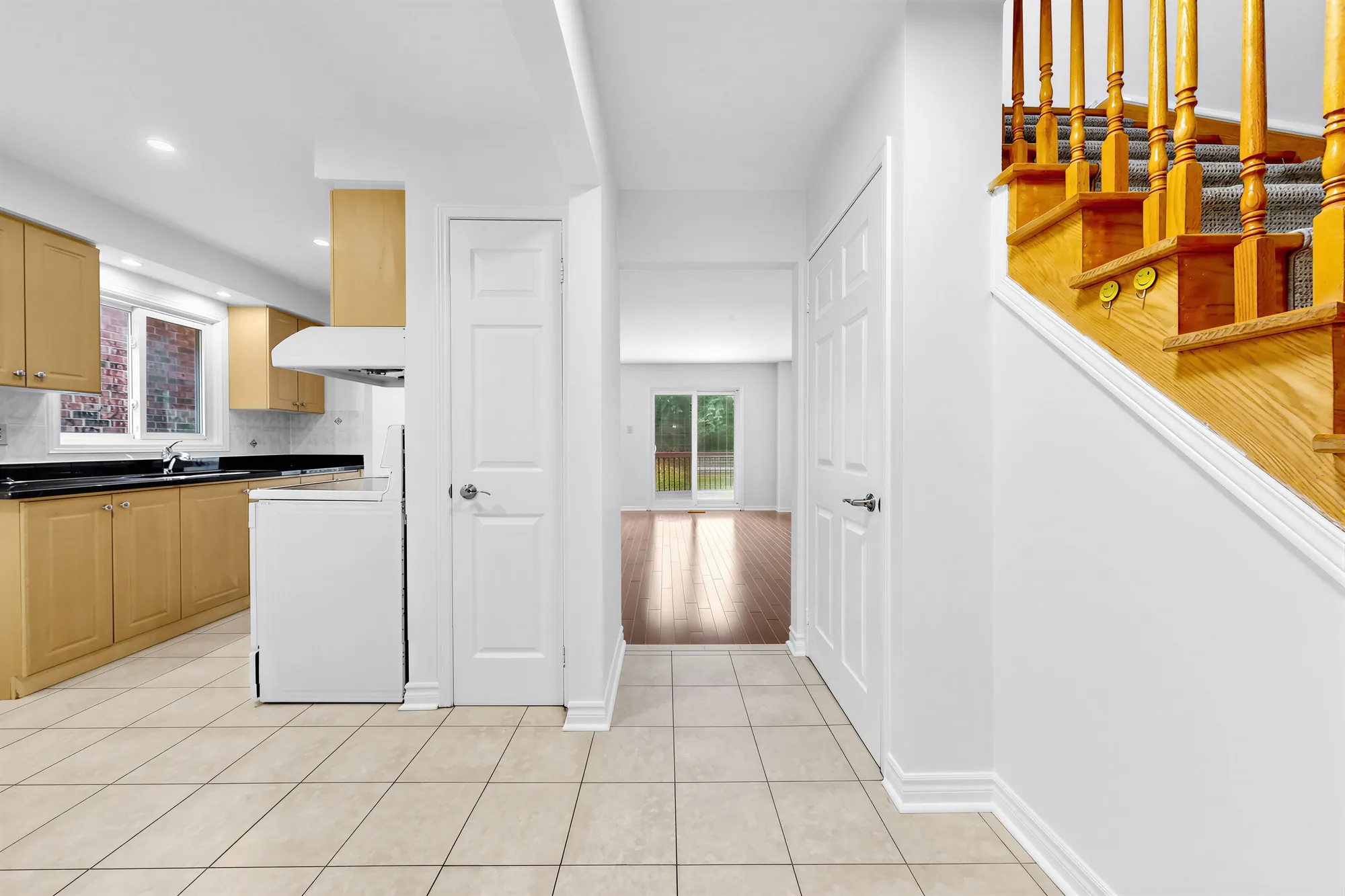 From the breakfast nook: the kitchen at the left, a pantry door, the hall through to the living room and its sliding door