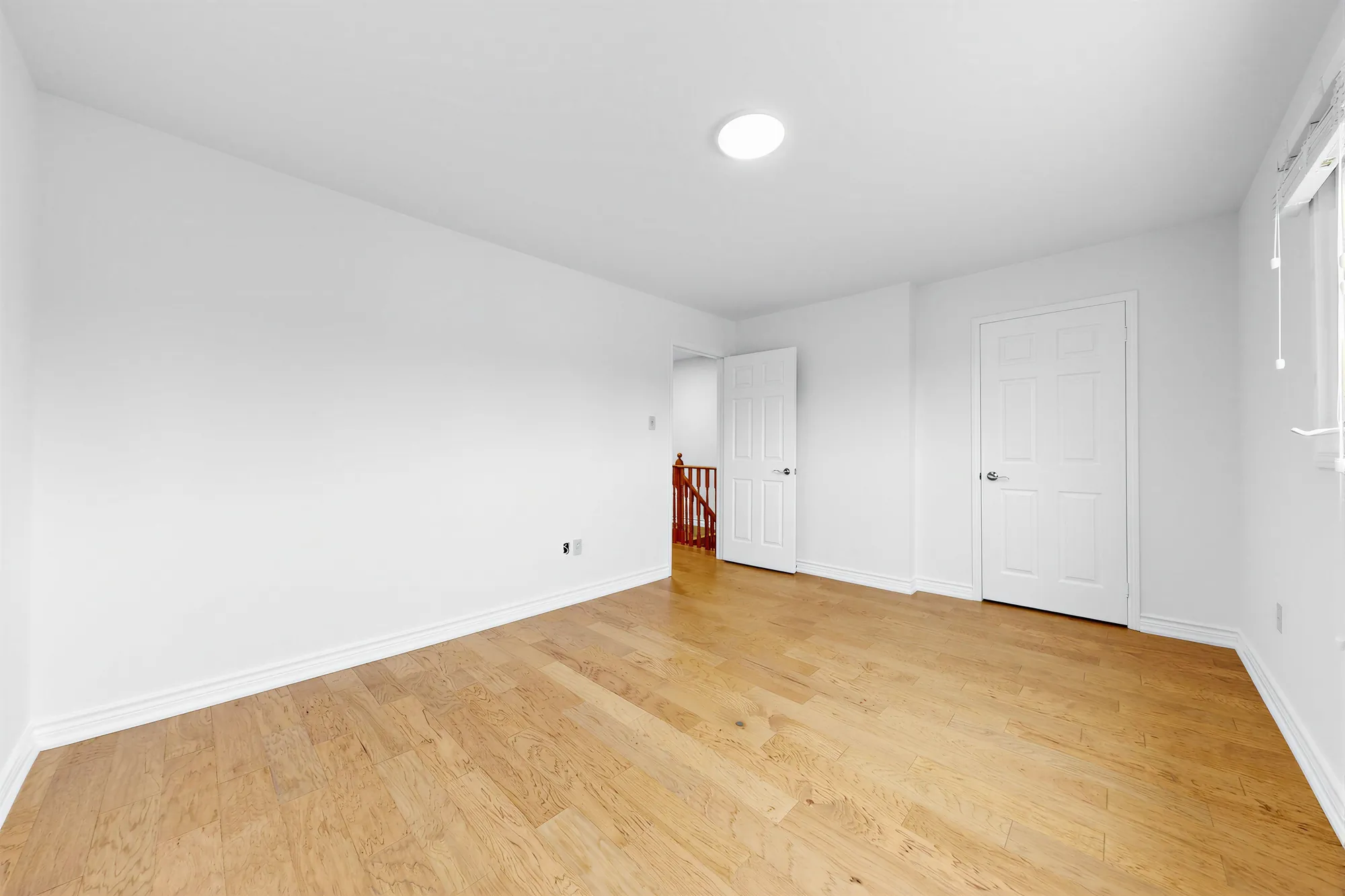 The primary bedroom toward the door to the hall and the closet